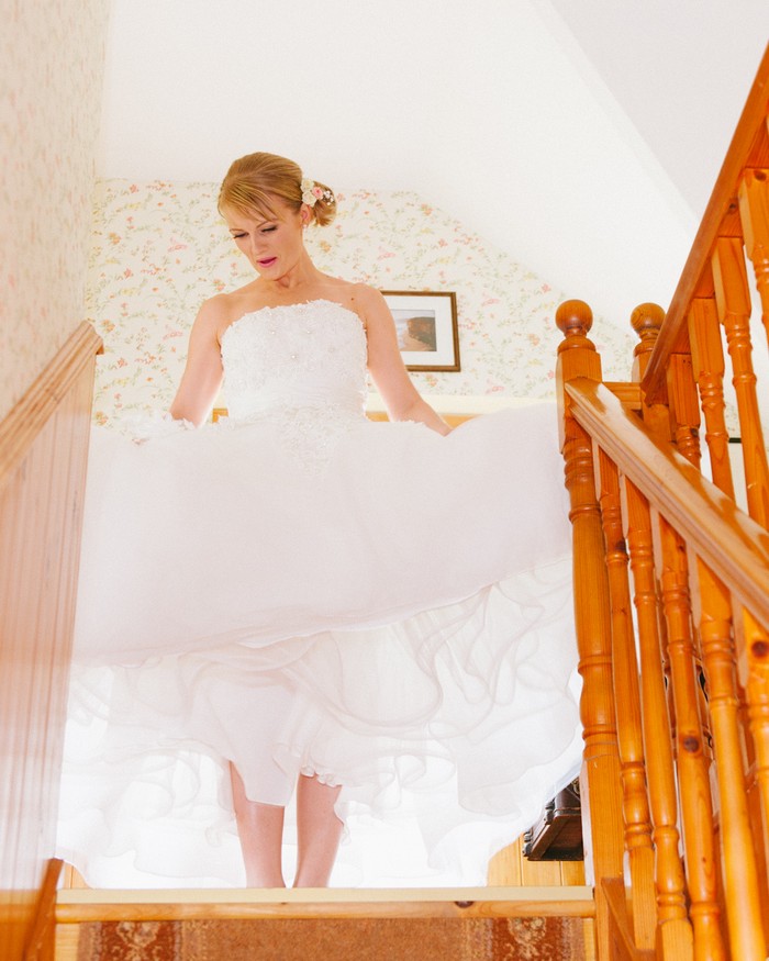 bride walking down stairs 50 style dress
